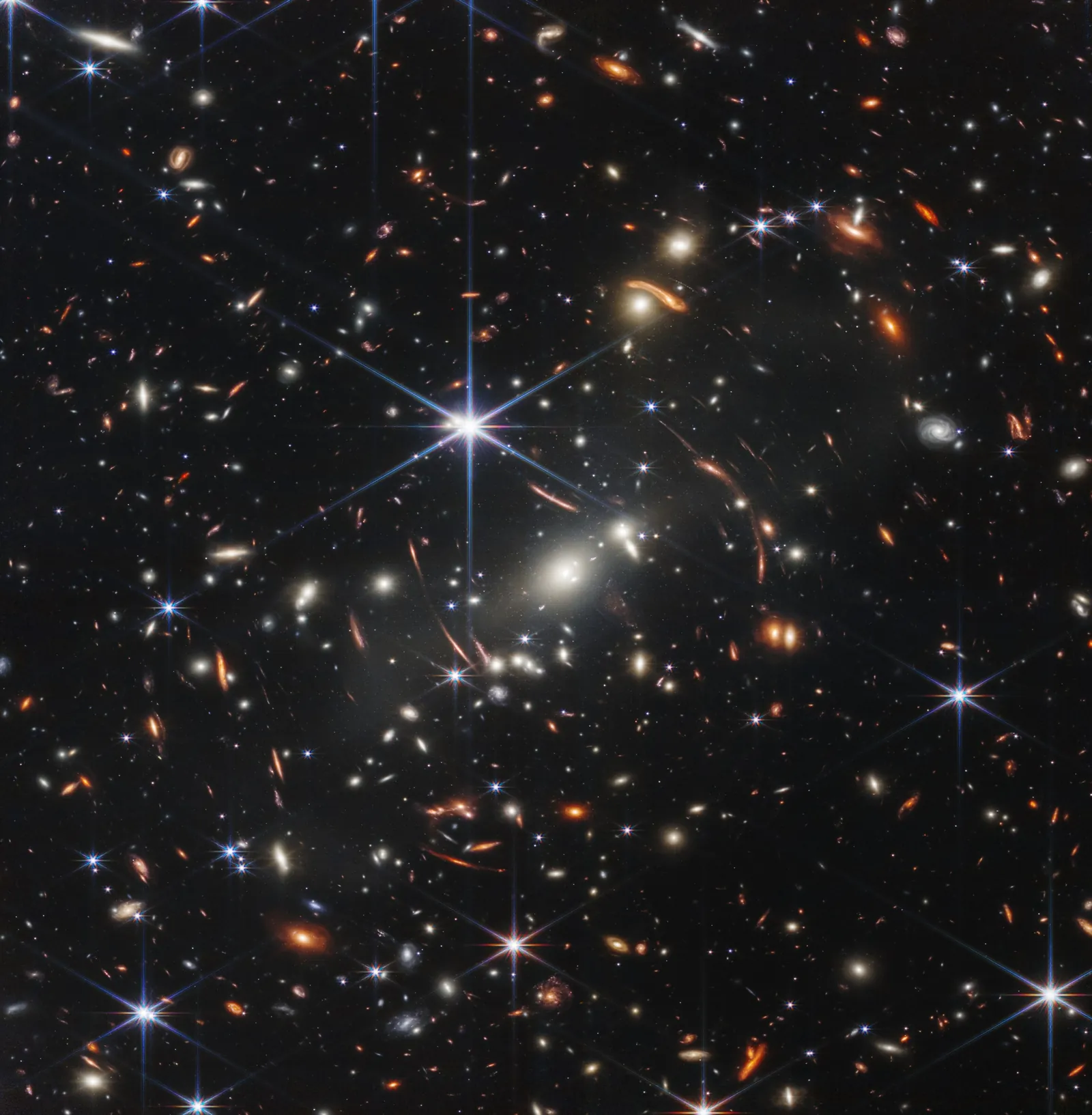 Webb's First Deep Field: thousands of distant galaxies behind the galaxy cluster SMACS 0723, some stretched into arcs by gravitational lensing.