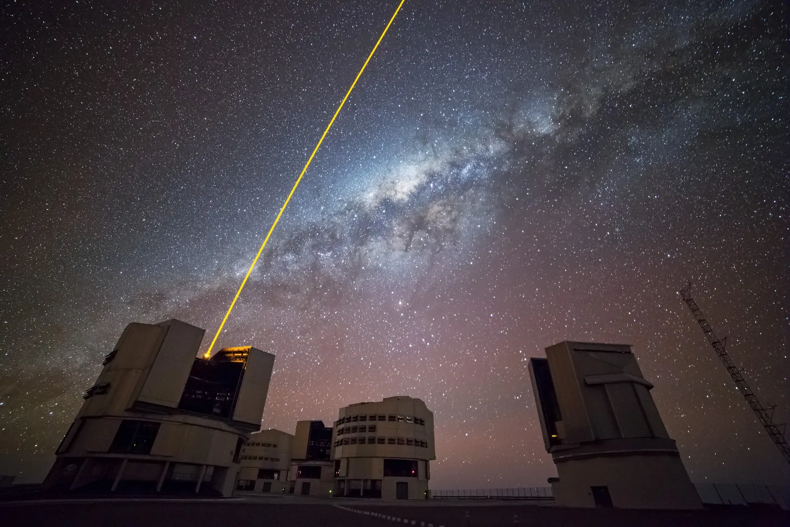 A laser beam shoots from one of the Very Large Telescope's unit telescopes at Paranal towards the bright centre of the Milky Way.