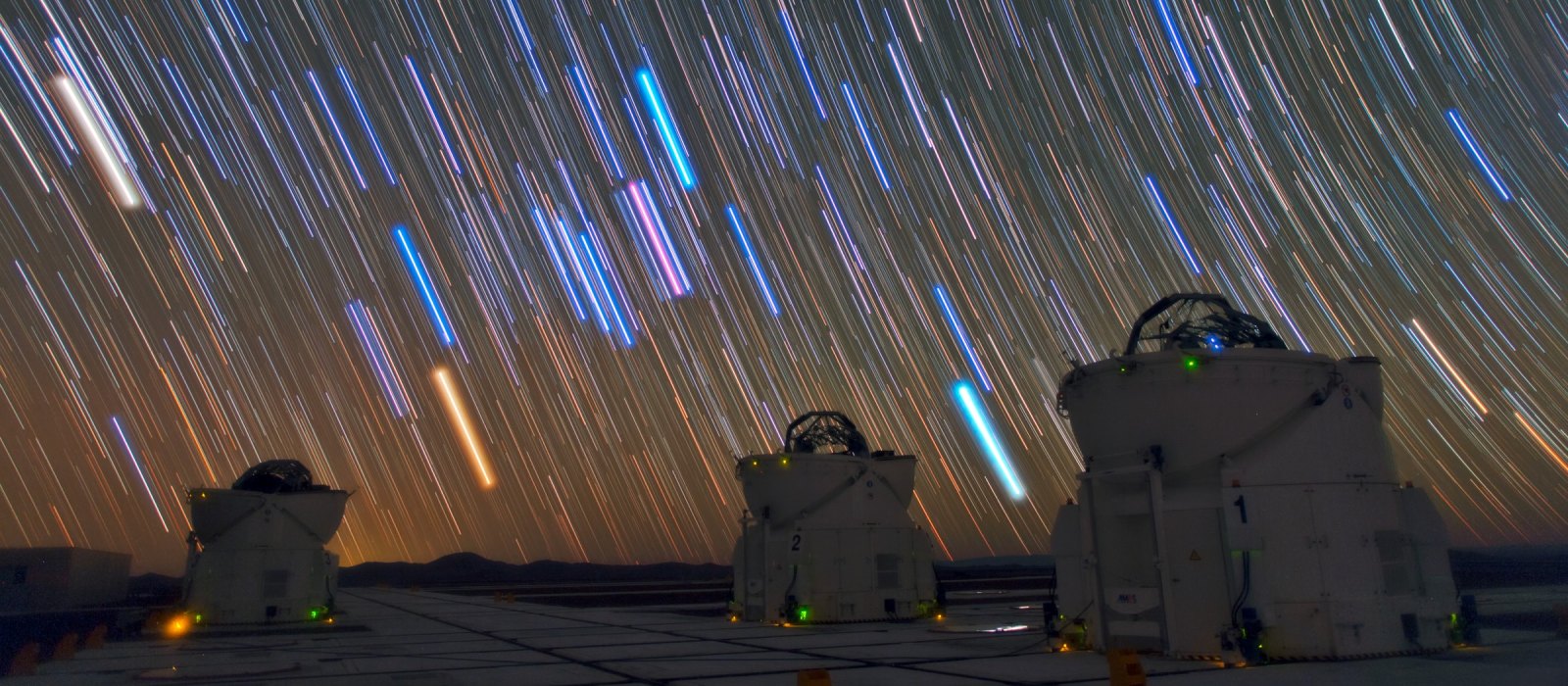 Star trails above three Auxiliary Telescopes of the Very Large Telescope at Paranal Observatory in Chile