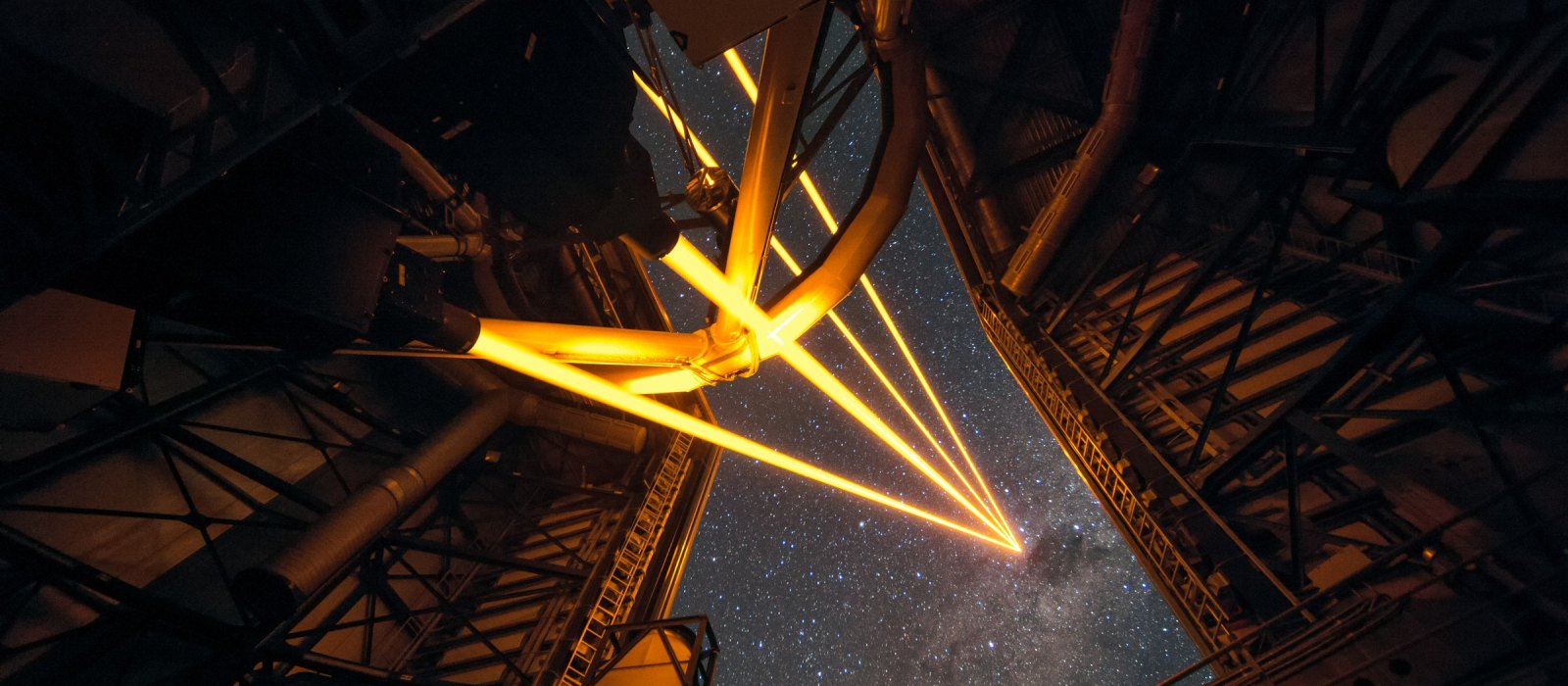 Four laser beams leave a Unit Telescope of the Very Large Telescope in Chile and create artificial guide stars for adaptive optics