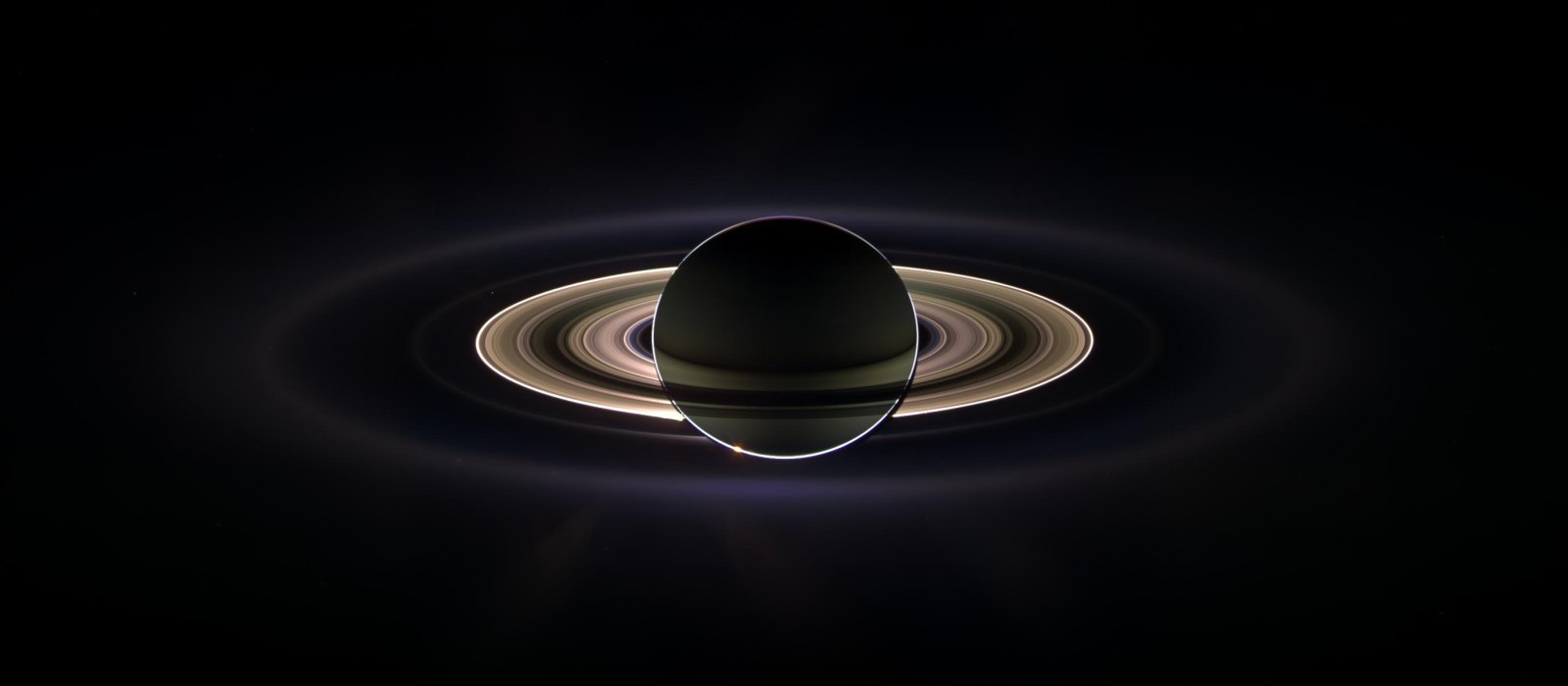 Saturn and its rings backlit by the Sun, photographed by the Cassini spacecraft from inside the shadow of the planet