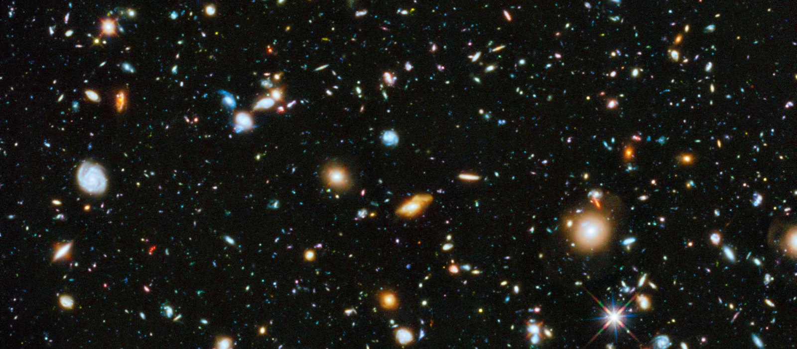 The Hubble Ultra Deep Field: thousands of faint galaxies of many shapes and redshifts on a dark sky